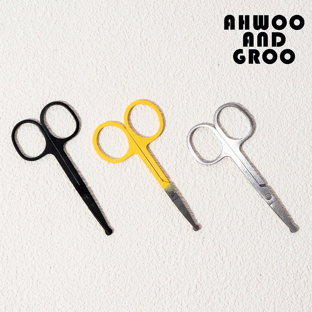 Three pairs of scissors in black, yellow, and silver on a textured white background with 'AHWOO AND GROO' text.